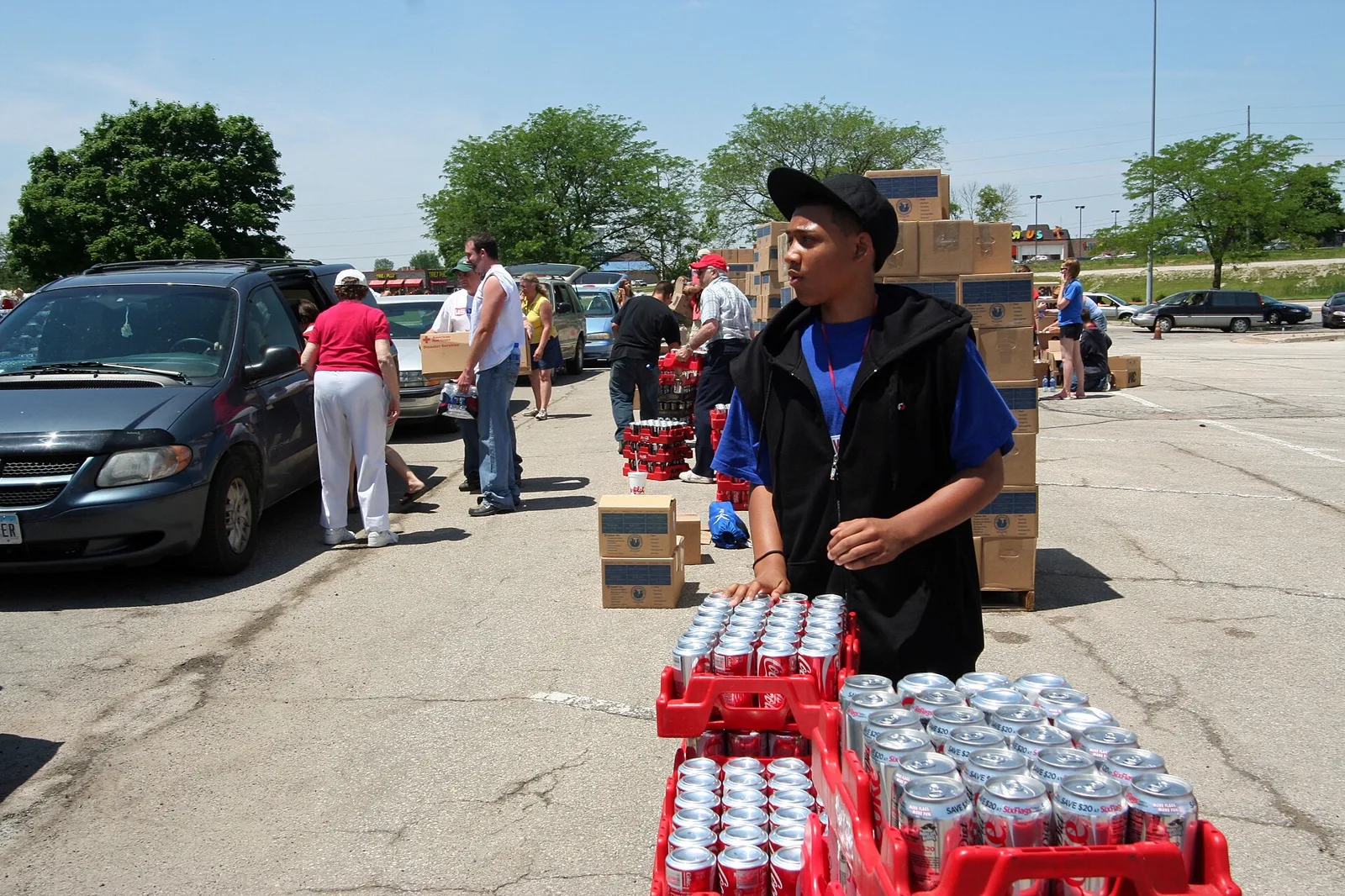 Volunteers unloading and distributing bottled water to families after a disaster