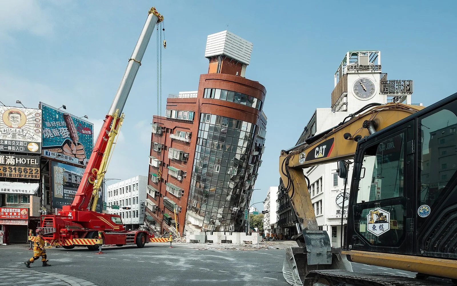 Rescue workers near the semi-collapsed ten-story Uranus Building on Xuanyuan Road after the 2024 Hualien earthquake.