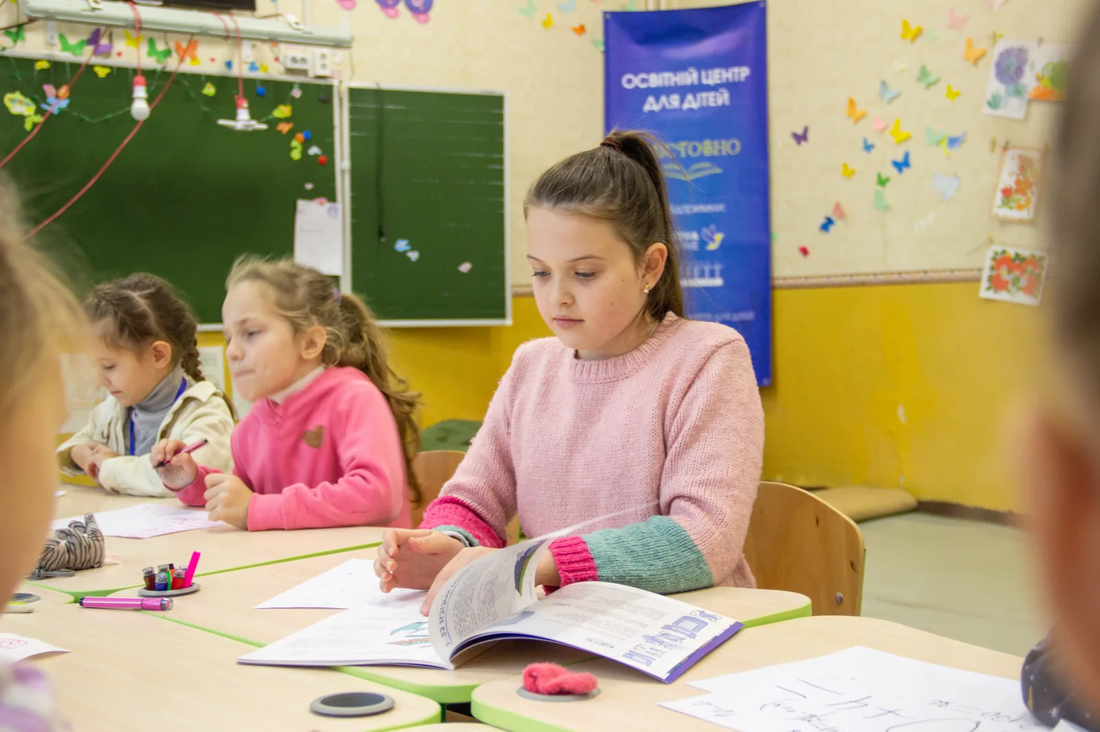 A mentor working with young people at an after-school programme