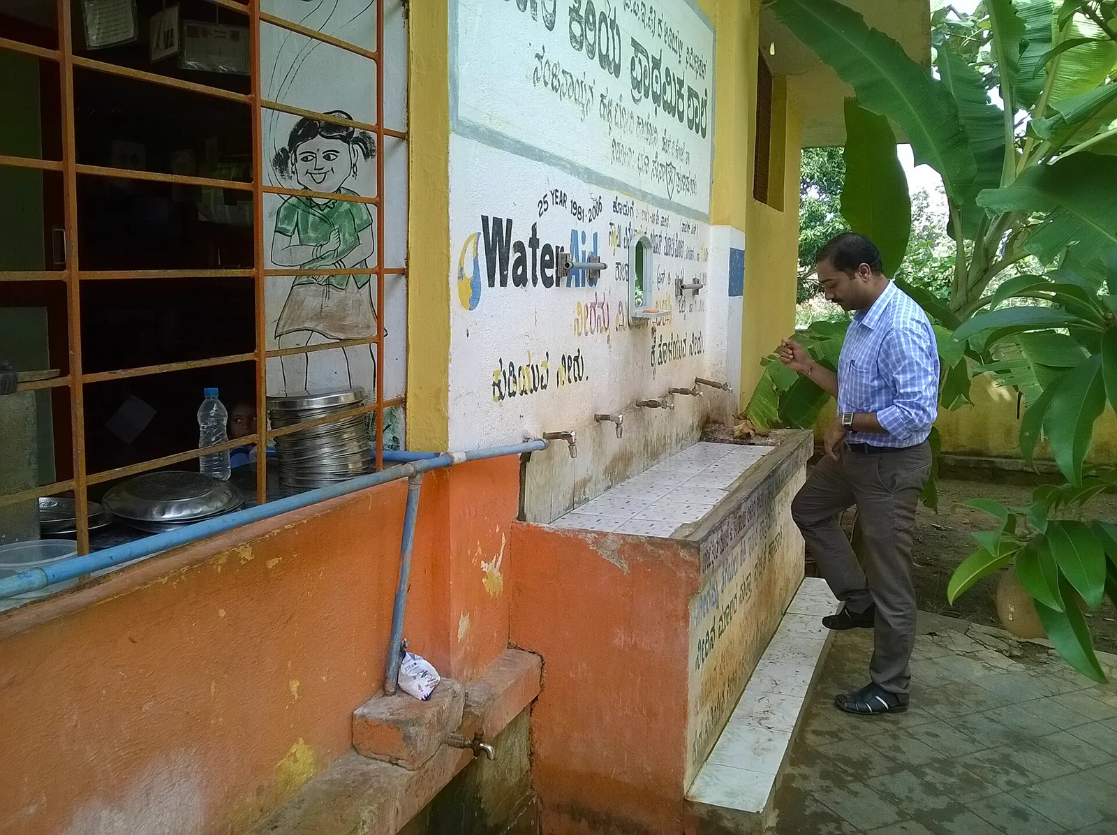 Children washing their hands at a school hygiene station