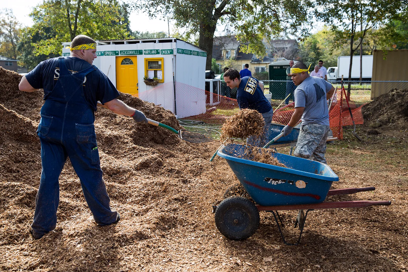 Neighbours and volunteers building a community playground together